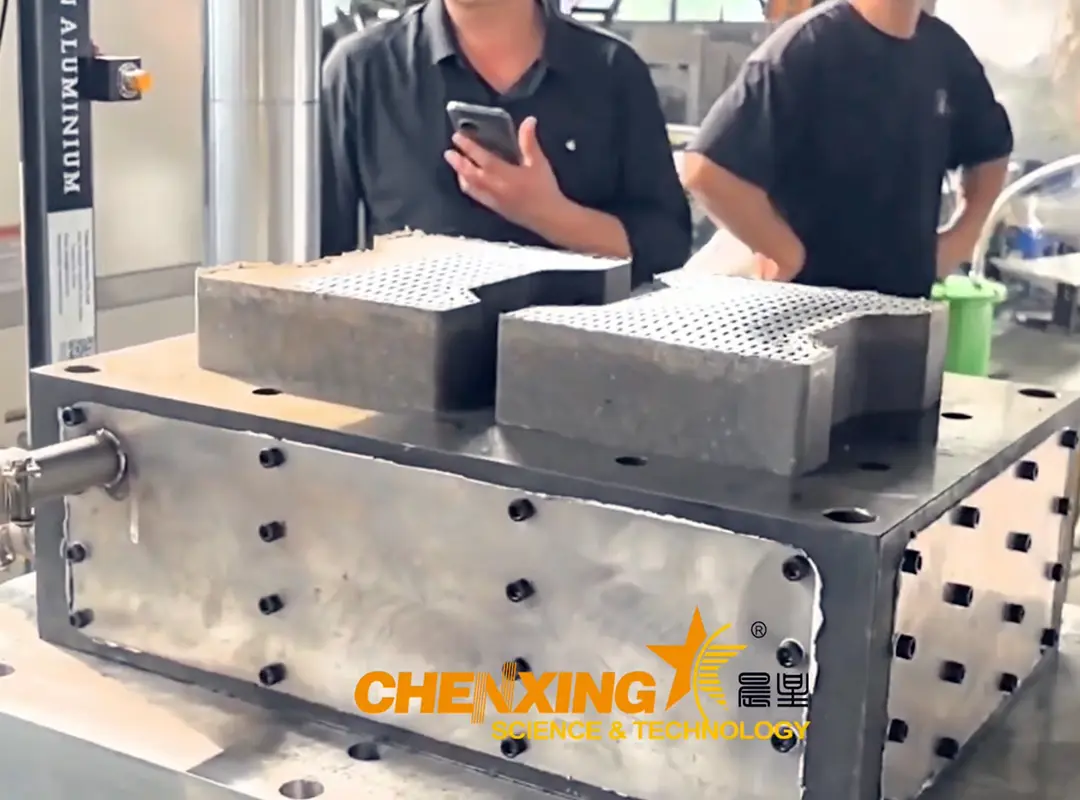 Melted HDPE and PP plastic being poured into metal molds for brick formation